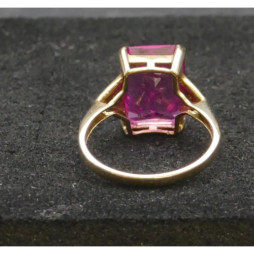 293 - A 9ct gold pink topaz ring flanked by small diamond chips, Size R, 4.4 grams gross