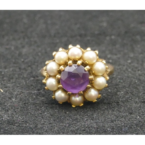 308 - A 9ct gold cluster ring set with centre amethyst surrounded by half pearls, Size K/L, 4.9 grams gros... 