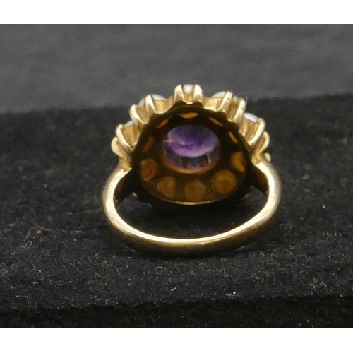 308 - A 9ct gold cluster ring set with centre amethyst surrounded by half pearls, Size K/L, 4.9 grams gros... 