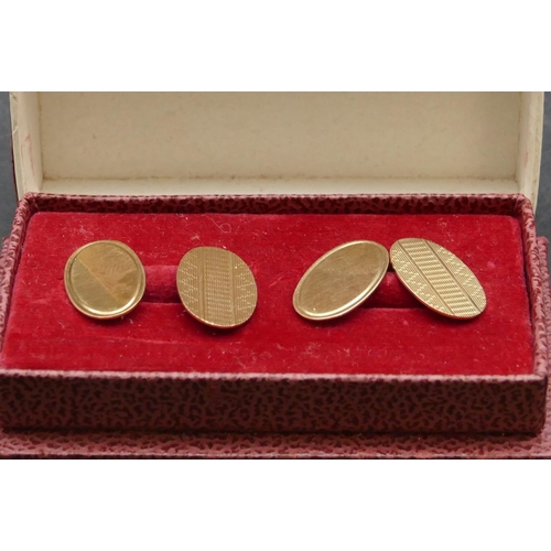 313 - A pair of 9ct gold gentlemen's oval cufflinks with engine turned decoration, 4.5 grams