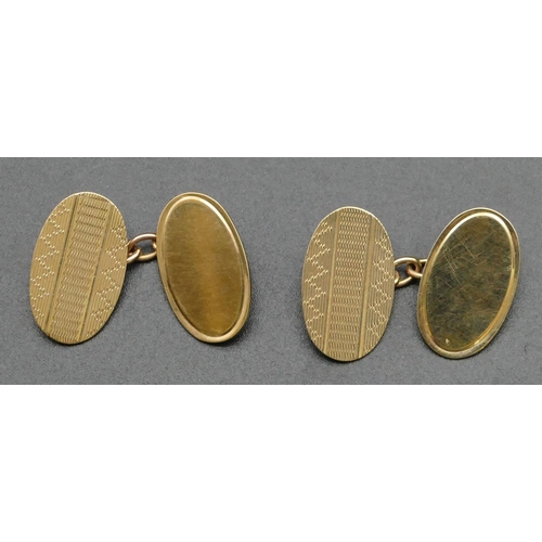 313 - A pair of 9ct gold gentlemen's oval cufflinks with engine turned decoration, 4.5 grams