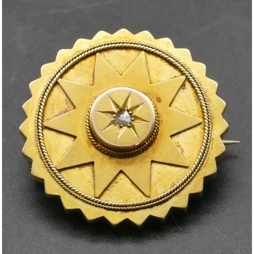 317 - A high carat gold round scalloped shaped brooch inset with rough cut diamond to centre, 3cm diameter... 