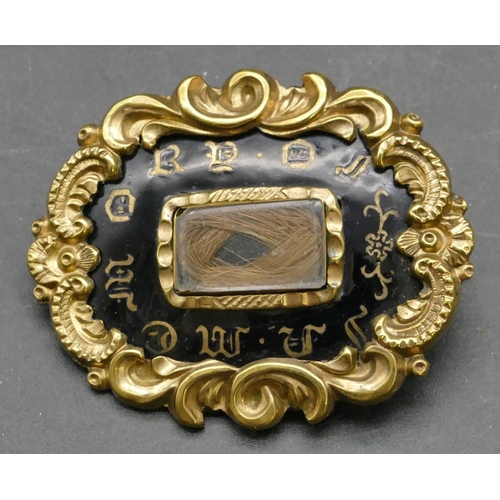 320 - A 19th Century rectangular scallop shaped mourning brooch with black and matted hair decoration and ... 