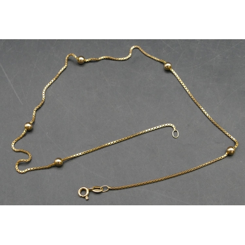 351 - A 9ct gold necklace mounted with 5 balls, 38cm long, 3.3 grams