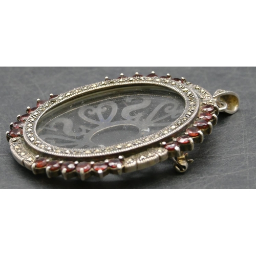 358 - A 925 silver oval pendant/brooch with cut steel and red stones to rim, 7.7cm high