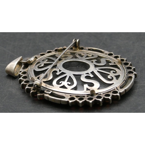 358 - A 925 silver oval pendant/brooch with cut steel and red stones to rim, 7.7cm high