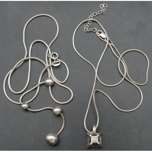 367 - A silver necklace with ball drops and another silver pendant with chain