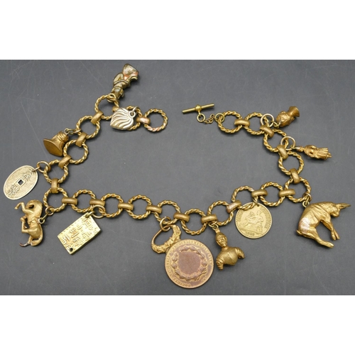 376 - A circular linked watch chain mounted with various gold plated charms