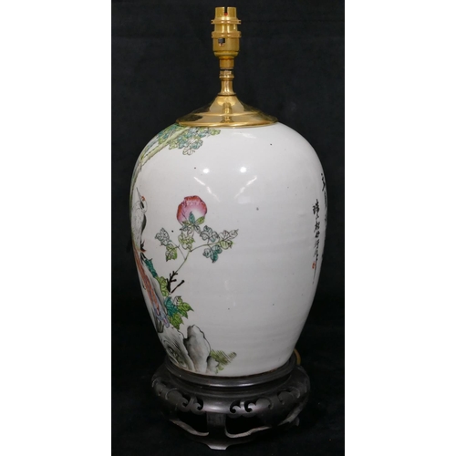 38 - An Oriental round bulbous shaped table lamp with multicoloured bird, tree, floral and leaf decoratio... 