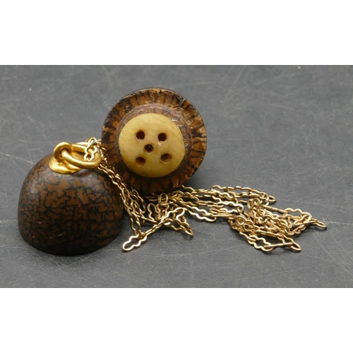 383 - A Papier-mâché egg shaped pendant with screw centre mounted on gold chain, chain 1.4 grams