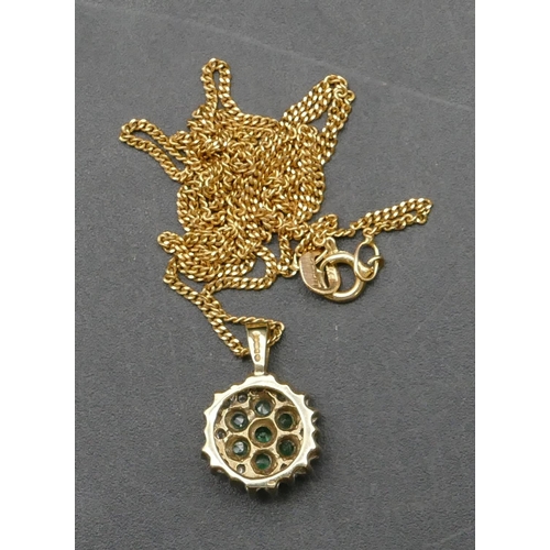 386 - A 9ct gold small circular pendant set with small emeralds and diamonds with gold chain, overall weig... 