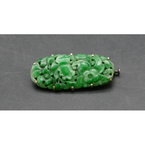 388 - An Oriental jade rectangular shaped brooch with carved and pierced floral and leaf decoration, 4cm l... 