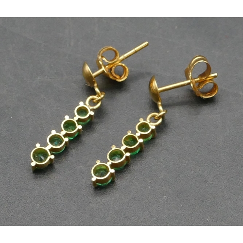 398 - A pair of 18ct gold small drop earrings mounted with green stones, 1.5 grams gross