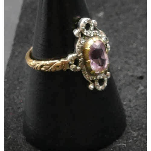 410 - A high carat gold ladies' rectangular shaped ring set with centre amethyst surrounded by small diamo... 