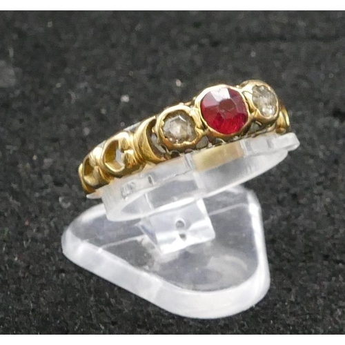 413 - A high carat gold ladies' 3 stone ring set with centre ruby flanked by 2 rough cut diamonds with pie... 