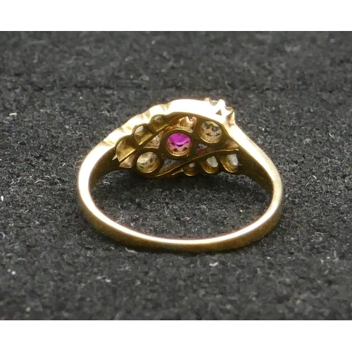 414 - A high carat gold 3 stone twist ring with centre ruby flanked by 2 diamonds, Size N, 2.9 grams gross