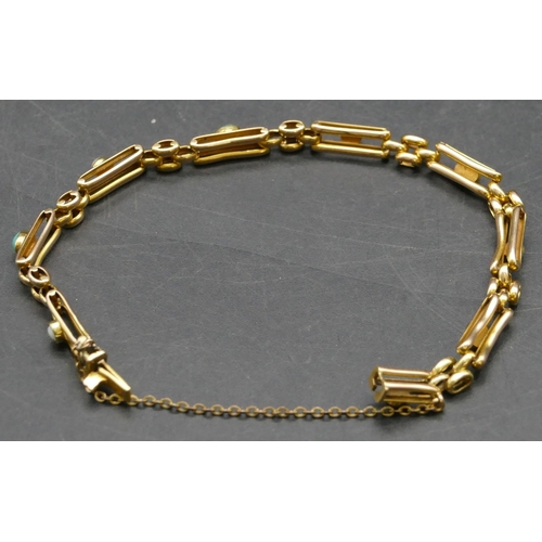 415 - A 15ct gold linked bracelet mounted with turquoise and half pearls, 7.7 grams gross