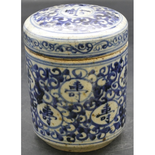 42 - An Oriental cylindrical lidded pot on blue and white ground with scroll decoration, 12.5cm high