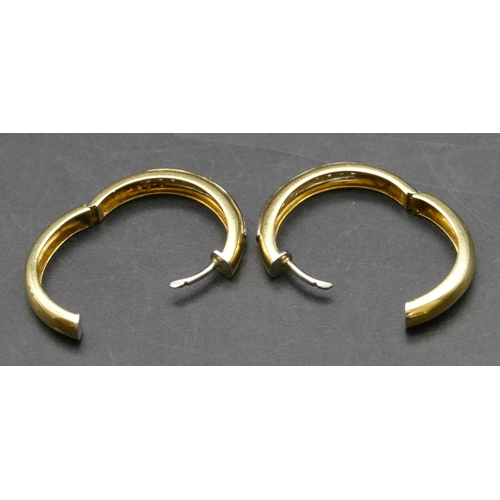 423 - A pair of 18ct gold circular hoop earrings, each inset with 11 diamonds, 2.6cm diameter, 9.3 grams g... 