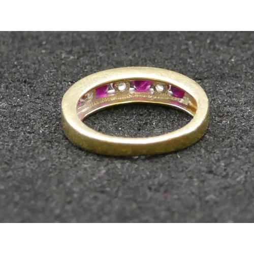 427 - An 18ct gold ladies' ring set with 4 square cut rubies interspersed by 3 diamonds, Size K/L, 4.1 gra... 