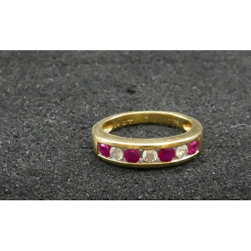 427 - An 18ct gold ladies' ring set with 4 square cut rubies interspersed by 3 diamonds, Size K/L, 4.1 gra... 