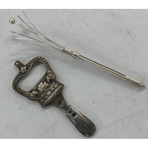 441 - A London silver mounted bottle opener in the form of a crown, also a silver swizzle stick (2)