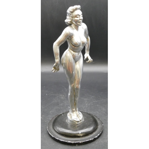 454 - An aluminium mascot in the form of a standing female nude on black sweeping base, 28cm high