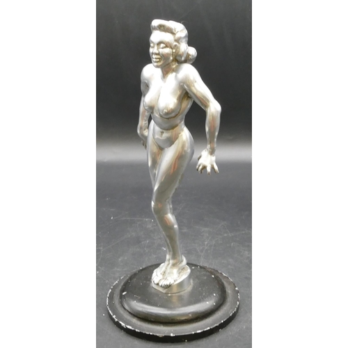 454 - An aluminium mascot in the form of a standing female nude on black sweeping base, 28cm high