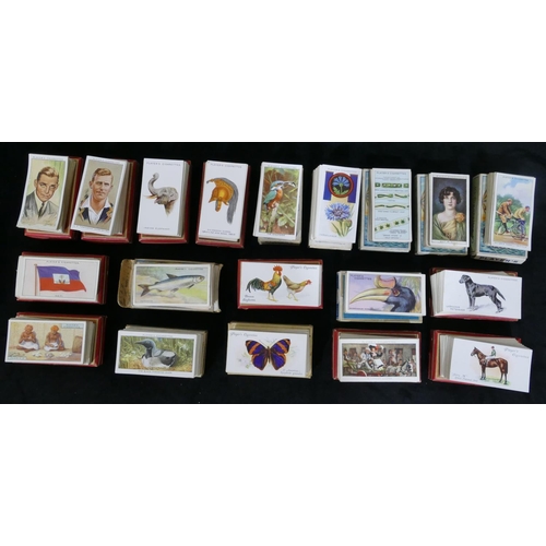 455 - A quantity of various cigarette cards - hats, flags, cinema stars, wild animal heads, dandies etc