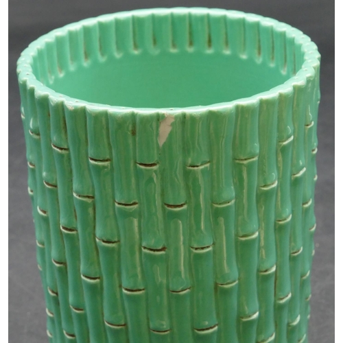 47 - An Oriental cylindrical brush pot in the form of bamboo on pale green ground, 11.8cm high