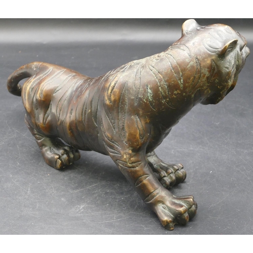 473 - A bronze figure of a tiger, 30cm long, 16cm high