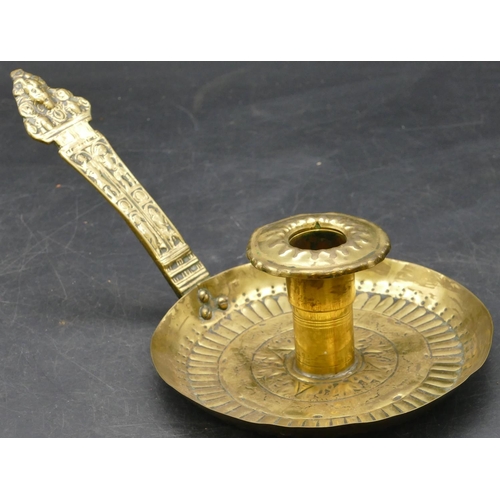 489 - An 18th Century Dutch brass chamber candlestick with raised embossed figure to handle, 24cm long