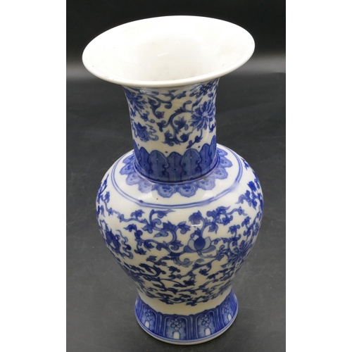 49 - An Oriental round bulbous thin necked trumpet shaped vase on blue and white ground with allover flor... 