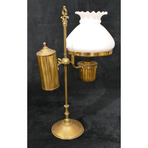 491 - A gilt metal oil lamp with opaline shade on round sweeping weighted base, centre carrying handle, 49... 