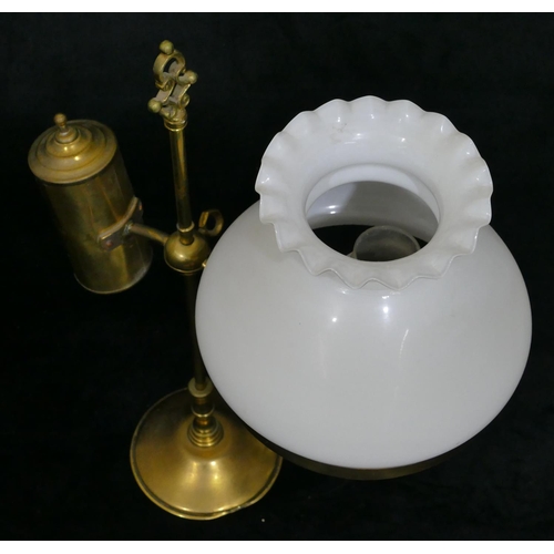 491 - A gilt metal oil lamp with opaline shade on round sweeping weighted base, centre carrying handle, 49... 