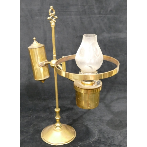 491 - A gilt metal oil lamp with opaline shade on round sweeping weighted base, centre carrying handle, 49... 