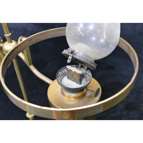 491 - A gilt metal oil lamp with opaline shade on round sweeping weighted base, centre carrying handle, 49... 