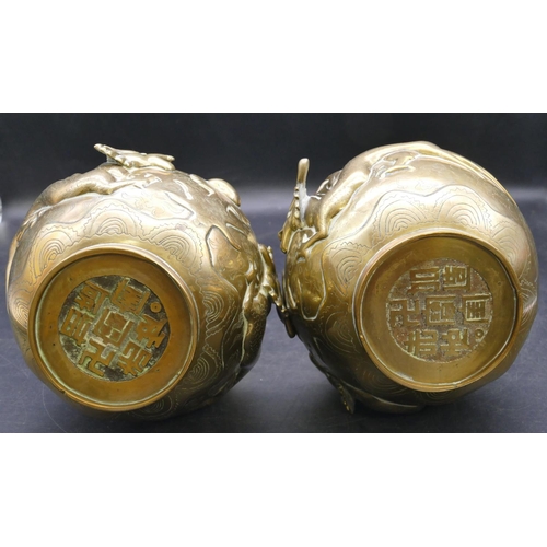 509 - A pair of Chinese gilt bronze round bulbous thin necked trumpet shaped vases with raised dragon moti... 