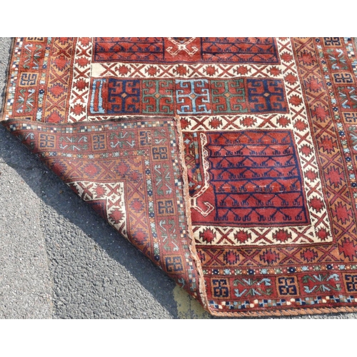 517 - A Persian rug on white, red and blue ground with various centre medallions, 189cm x 150cm