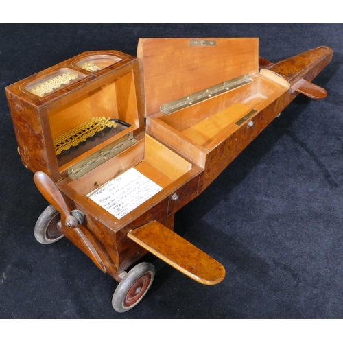 559 - An early 20th Century maple jewellery box in the form of an aeroplane with propeller, 48cm long