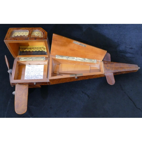 559 - An early 20th Century maple jewellery box in the form of an aeroplane with propeller, 48cm long