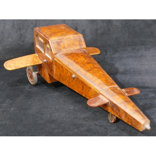 559 - An early 20th Century maple jewellery box in the form of an aeroplane with propeller, 48cm long