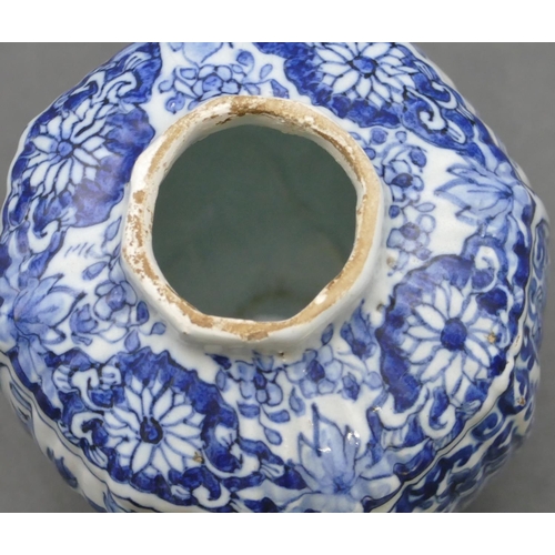 58 - A small Delft blue and white round bulbous thin necked lidded vase with allover floral, leaf and scr... 