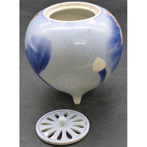 61 - An Oriental round bulbous shaped koro with pierced cover on pale blue ground with floral and leaf de... 