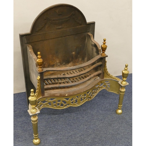 630 - A heavy cast iron and gilt metal fireplace with pierced decoration, turned finials, 66cm wide, 34cm ... 