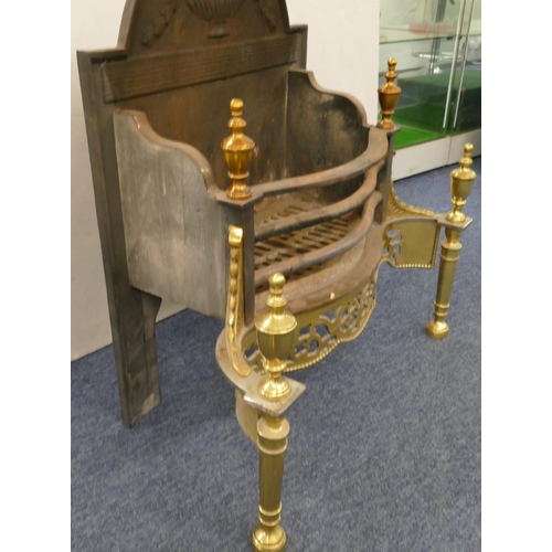 630 - A heavy cast iron and gilt metal fireplace with pierced decoration, turned finials, 66cm wide, 34cm ... 