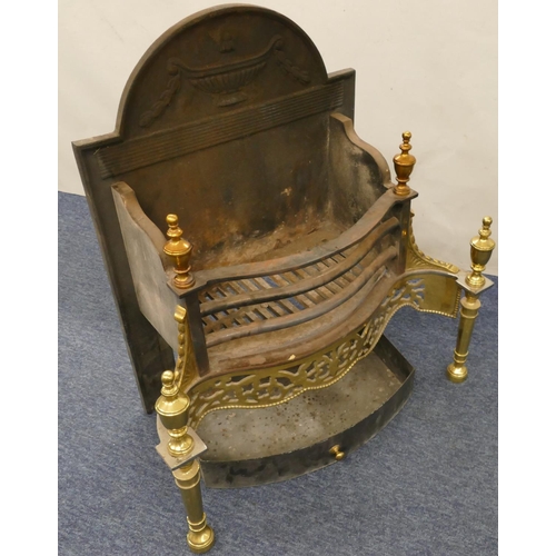 630 - A heavy cast iron and gilt metal fireplace with pierced decoration, turned finials, 66cm wide, 34cm ... 