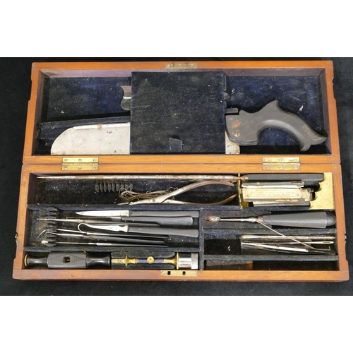 638 - A 19th Century mahogany cased field surgeon's amputation kit, comprising saw, scalpels etc. with ebo... 