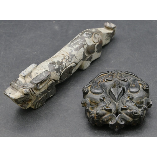 640 - A black carved hardstone amulet in the form of dragons, 5.5cm high, also another Oriental hardstone ... 