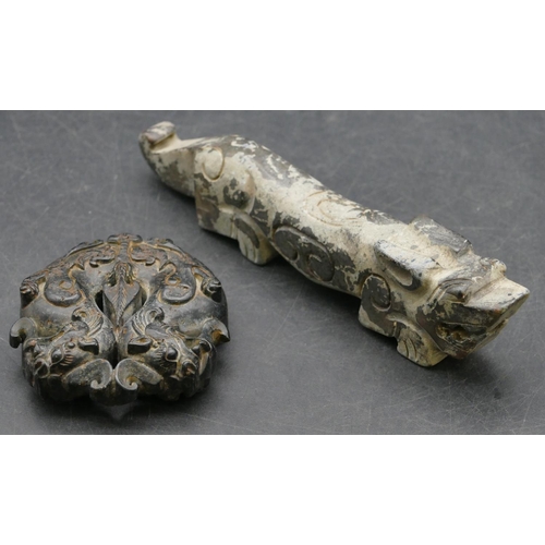 640 - A black carved hardstone amulet in the form of dragons, 5.5cm high, also another Oriental hardstone ... 